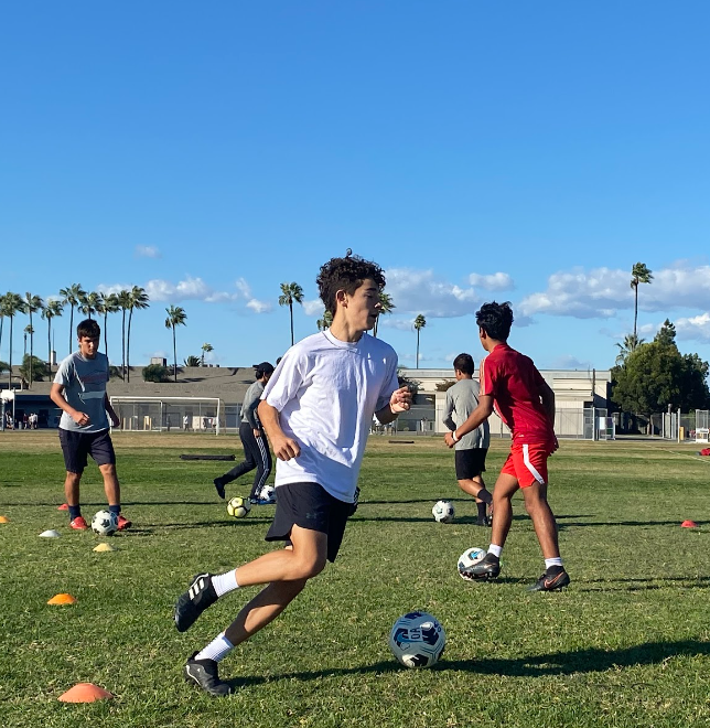 Kicking Off: Junior Miguel Alcala and the soccer team prepare for the upcoming season with some motor drills.