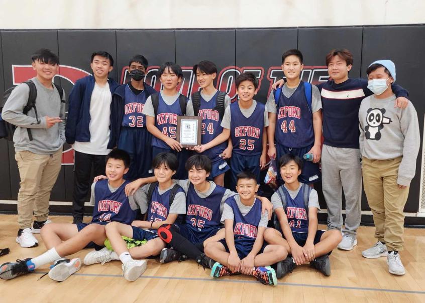 The seventh grade junior high boys’ basketball poses after a hard-earned third-place victory in their tournament.  