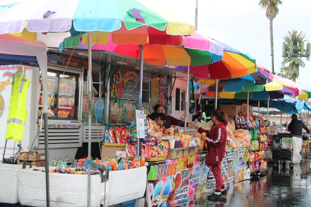 Mouth-watering snacks: Food trucks at the Cypress College swap meet offer an abundant amount of cultural snacks such as raspados, chicarrones, and chamoy-drenched fruit. (Photo by Miriam Santos)
