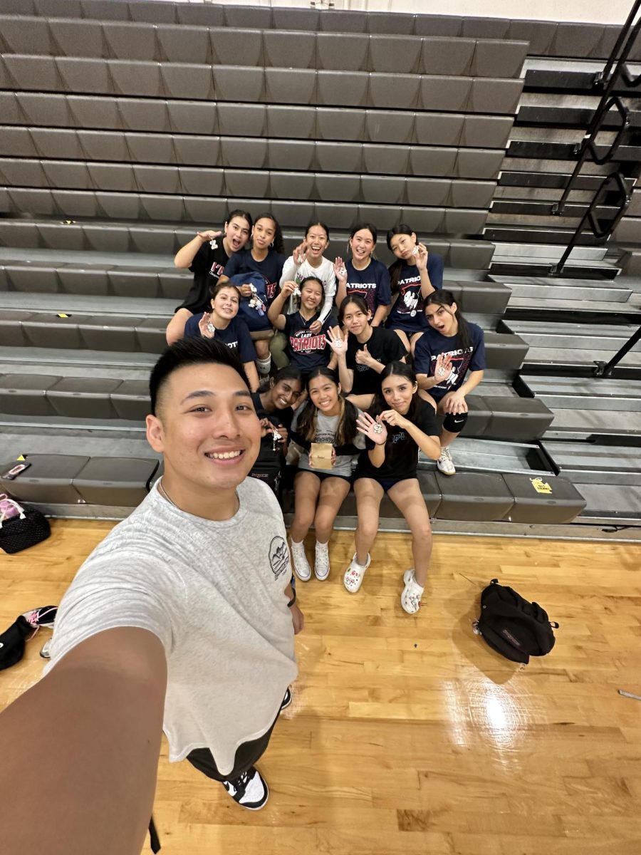 Selfie Time!: Back from a recent trip to Hawaii, Coach Anton Nguyen (left) gifts his JV Girls Volleyball team with souvenirs from Kawai after a preseason practice. (Photo by Brandy Nguyen)