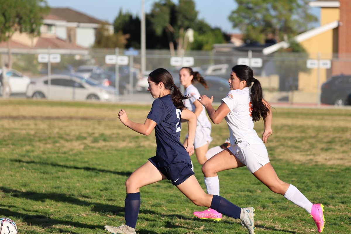 Forward Maya Diaz advances ball ahead of opposing defense in home game against Samueli Academy. (Photo Courtesy of Girls Soccer)