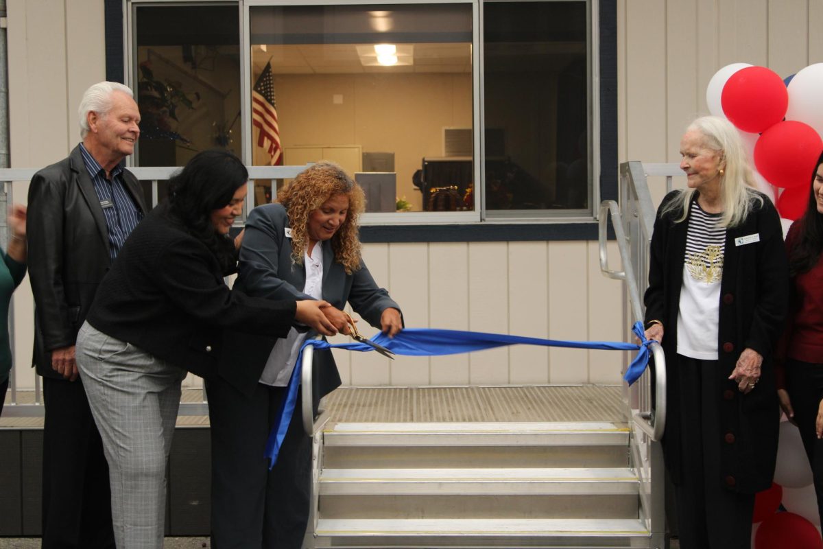 MAKING IT OFFICIAL: Oxford Academy FACES Karen Ortega and Anaheim Union High School District Board of Trustees President Annemarie Randle-Trejo cut the ribbon to officially open Oxford's Family Center as Trustees Brian O'Neal and Katherine Smith look on.