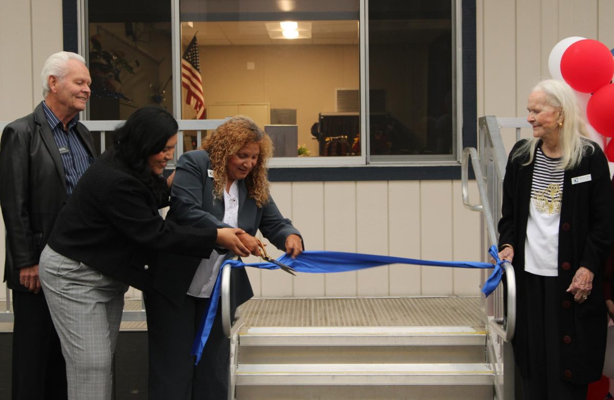 MAKING IT OFFICIAL: Oxford Academy FACES Karen Ortega and Anaheim Union High School District Board of Trustees President Annemarie Randle-Trejo cut the ribbon to officially open Oxford's Family Center as Trustees Brian O'Neal and Katherine Smith look on.