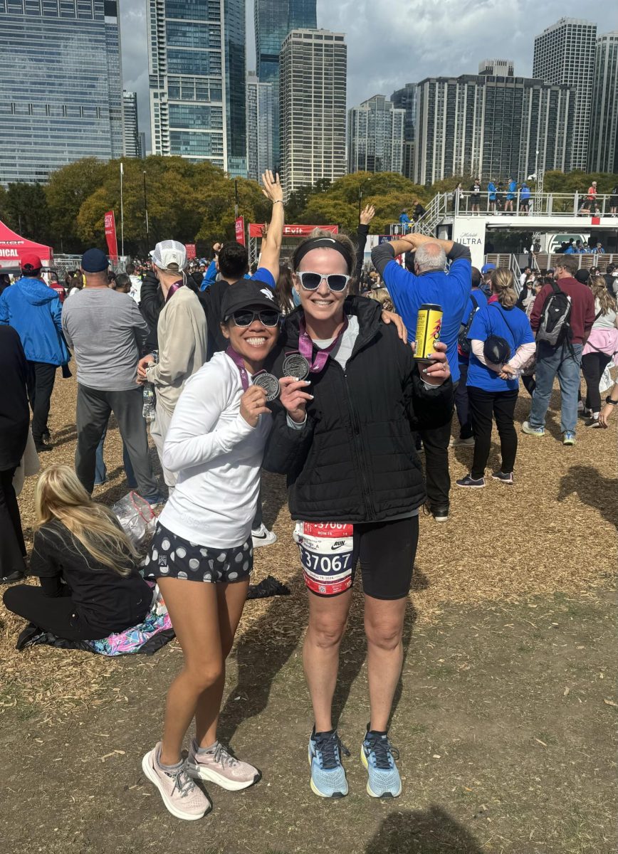 TRACK STARS: Mrs. Catherine Fong (left) and Mrs. Danielle Heath (right) pose with their 'star' medal after completing the Chicago Marathon. 