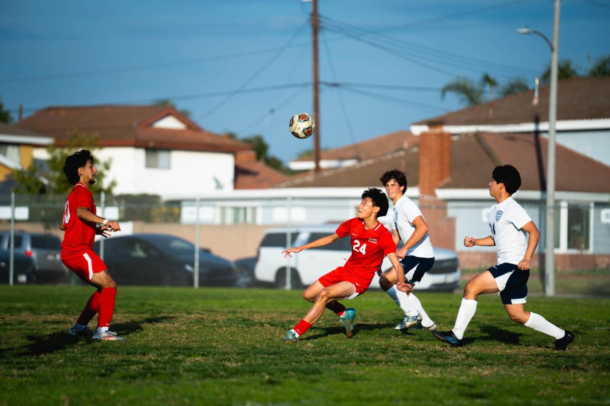 USING THEIR HEADS: Junior Slava Lee and Senior Carlos Miranda go in for the head and chest bump in their 5-1 win against Pacifica Christian. 