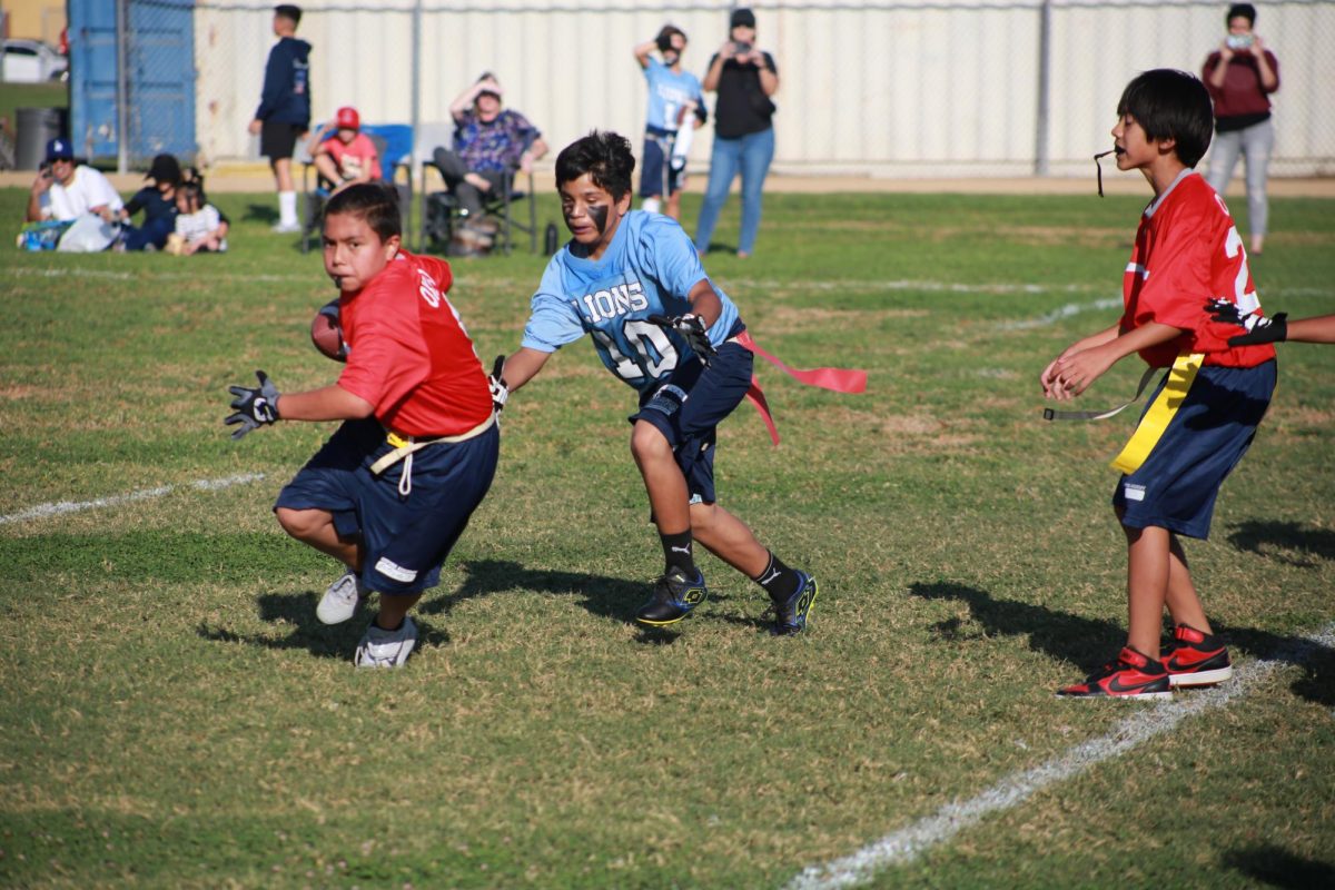 TAKING ON THE CHALLENGE: Junior High flag football athletes run to secure the ball during a match against Lexington Junior High