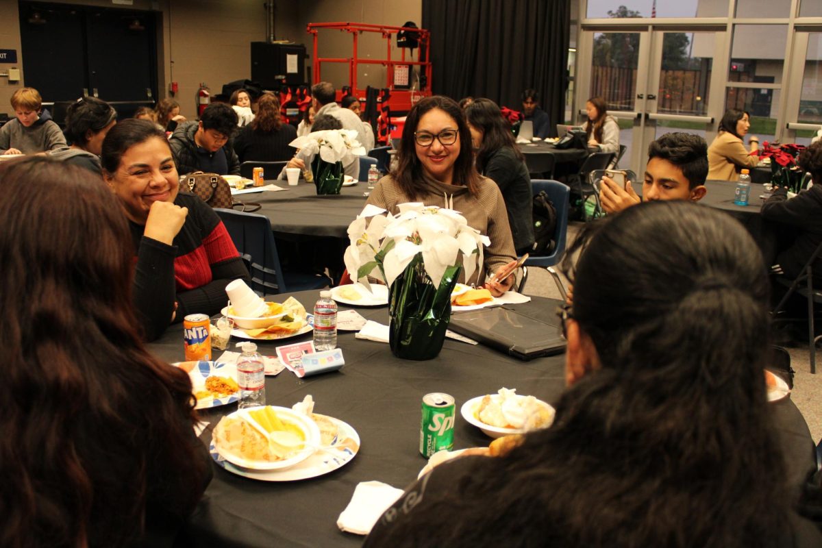 CELEBRATING TOGETHER: An Oxford family enjoys cultural foods from the posada.