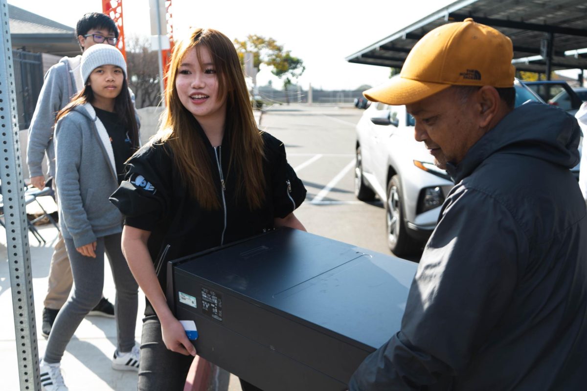 CLEANING UP THE COMMUNITY: OA Robotics and ECO members work together to collect electronic waste from the community during their Servathon event 