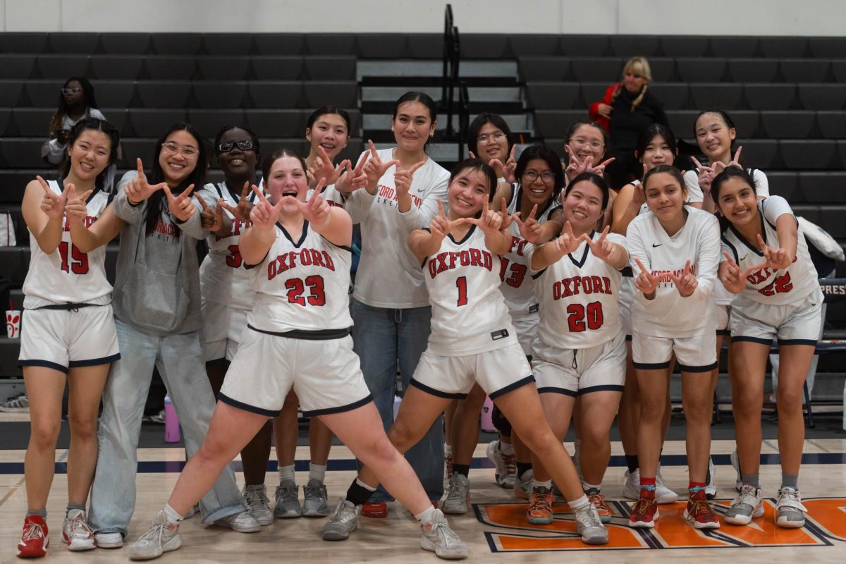 W is for Winners: The girls basketball team poses for a celebration photo after winning their CIF playoffs against Faith Baptist High School 