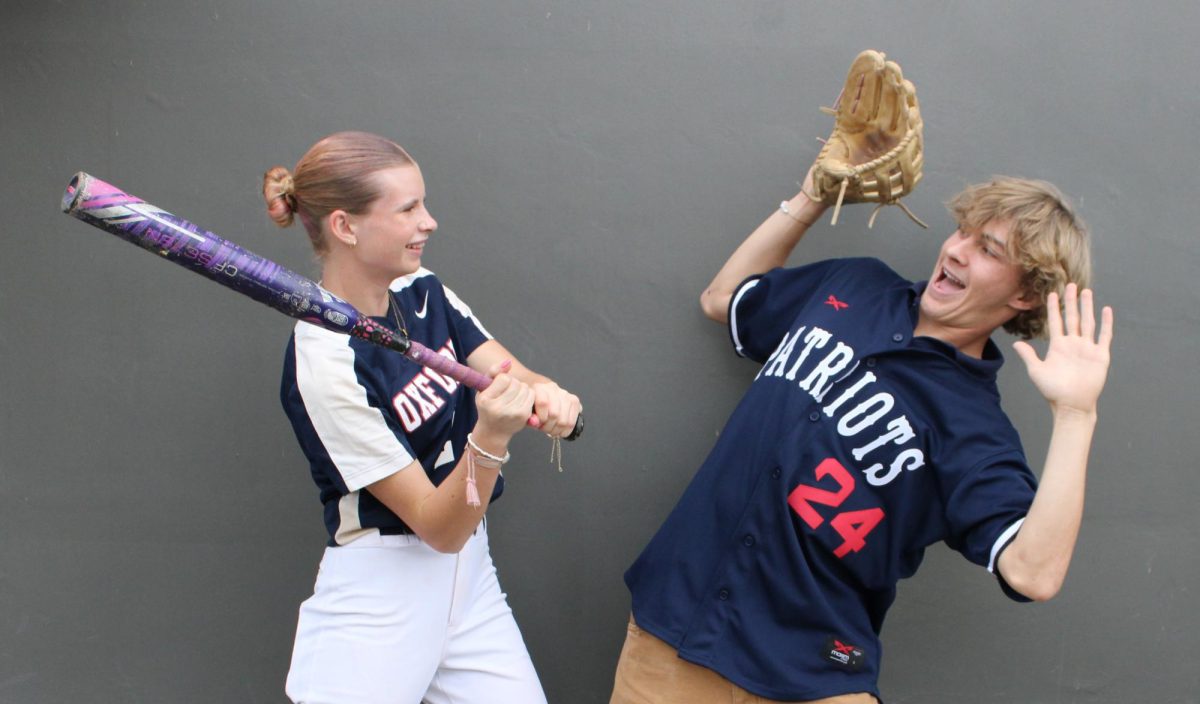 Sibling Magic: Shay shows off her power at the plate, knocking big brother Mac right off his feet! (Photo by Mikaela Woo) 