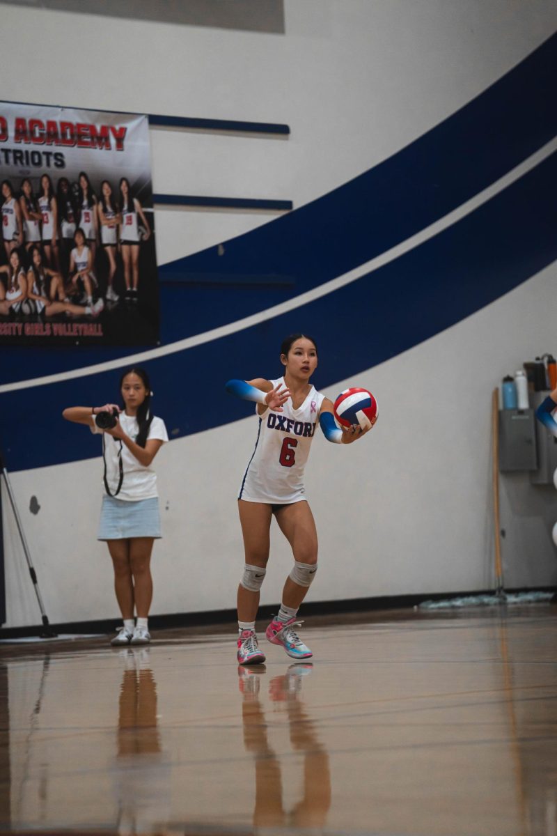 VOLLEYBALL STAR: Serena Mai serves the volleyball in an Oxford Academy homegame on September 15.