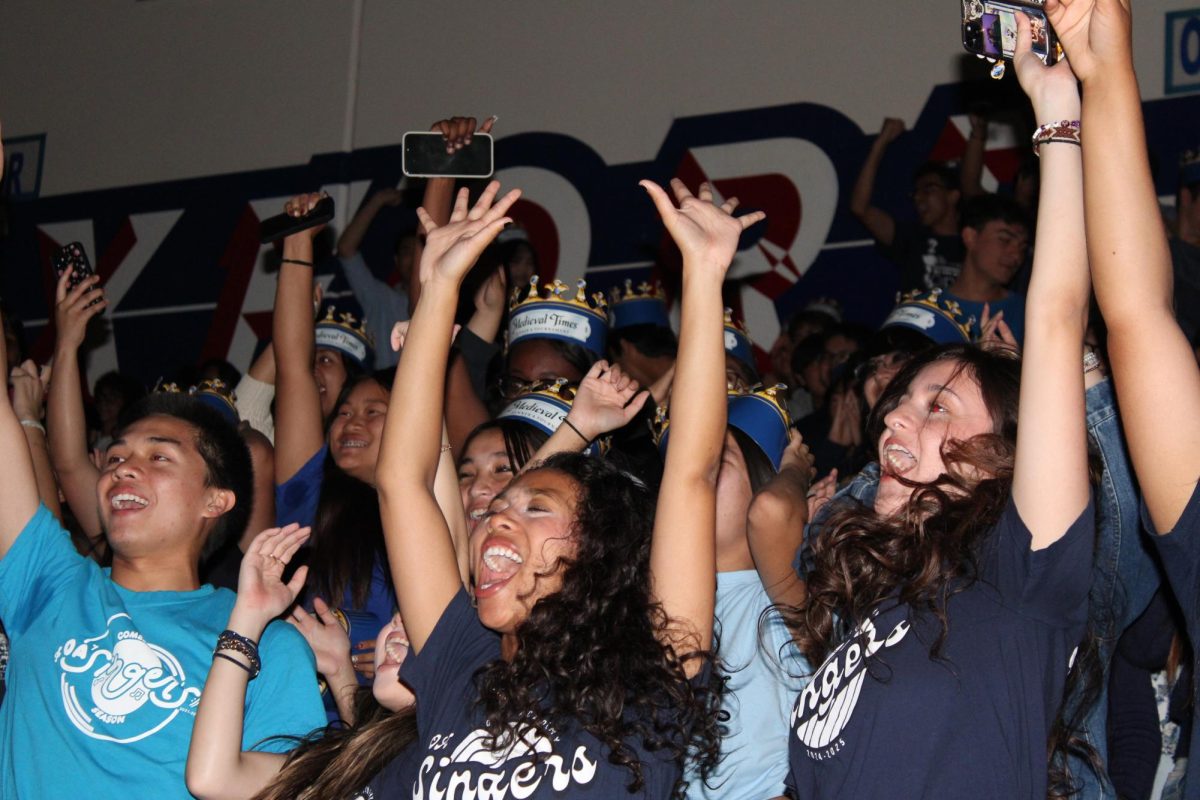 CLASS SPIRIT Ava Pitts (12), Roi Franco Barros (12), and Katarina Espinosa (12) cheering with patriot pride during the Back To School Rally