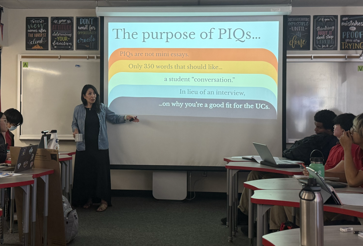 APPLYING SMARTER: Mrs. Casanova, using insight from UC conferences, presents a lesson on maximizing the impact of one’s UC Personal Insight Questions to her AVID Senior Seminar class. (Photo by Tam-Ai Van)