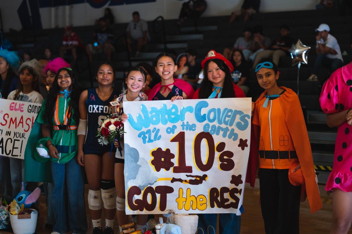 SENIOR NIGHT CELEBRATION: Varsity volleyball captain Chloe Nguyen poses with her dressed up underclassmen in honor of her final Senior Night.