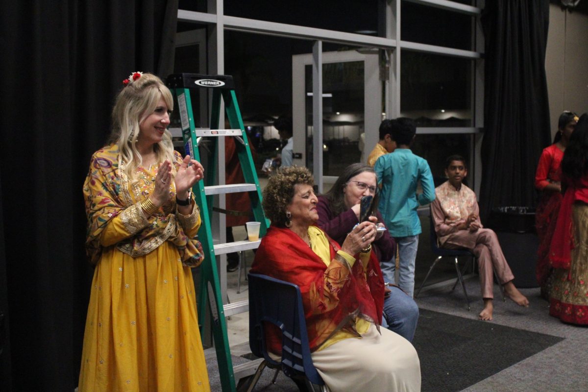 STAFF SUPPORT: Principal Houston, Ms. Sanchez, and Ms. Matic smile as they watch students dance