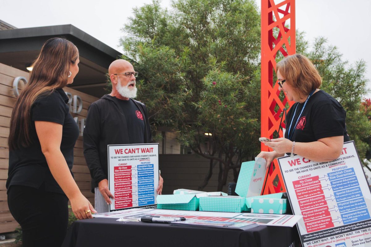 RALLYING FOR CHANGE: CTA Member Mia Colación and Oxford teachers, Dr. Hind and Mr. Taylor prepare for the rally.