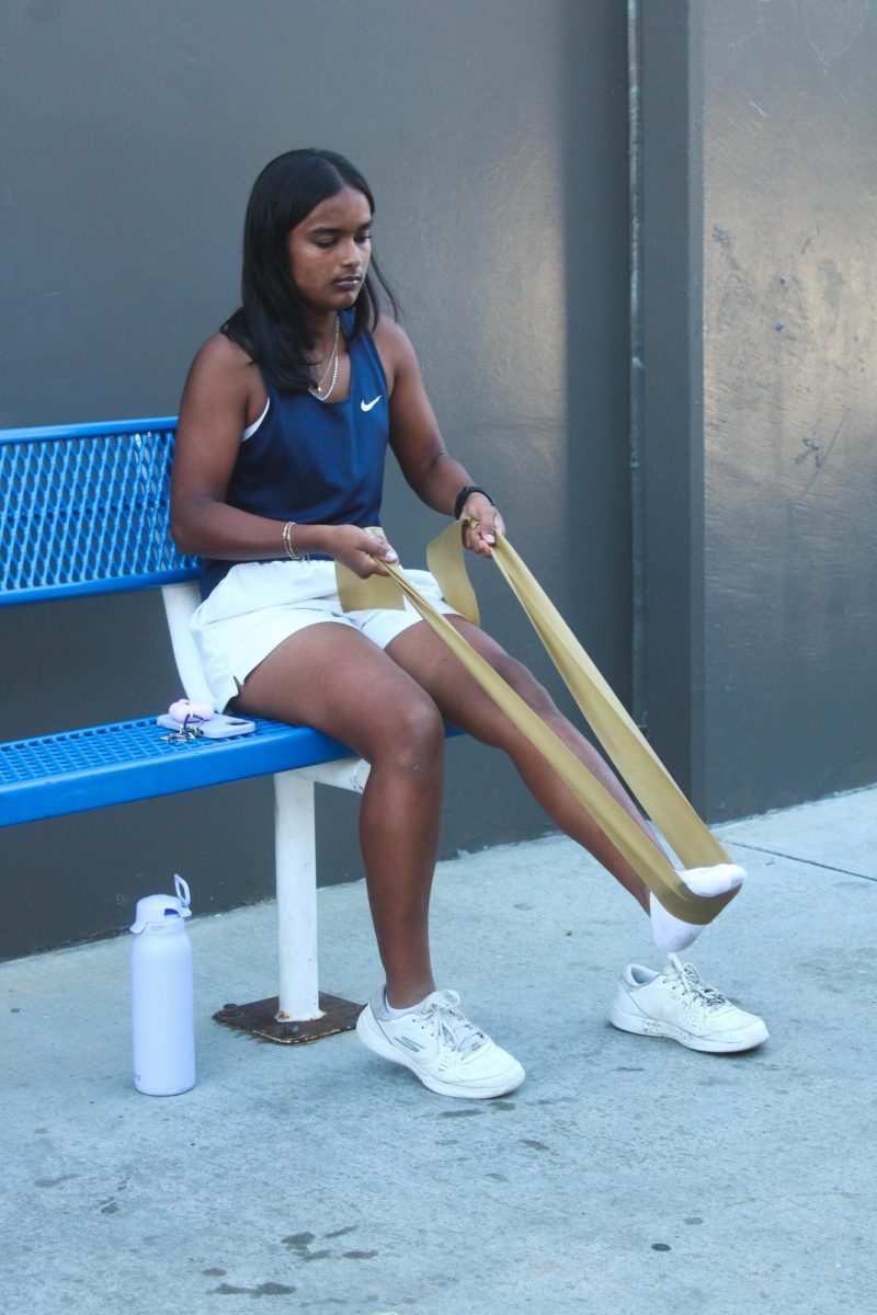 RECOVERY AND RESILIENCE: Sadhvi Iriva (sophomore) doing physical therapy under the guidance of Oxford Academy’s athletic trainer Courtney Flynn.
