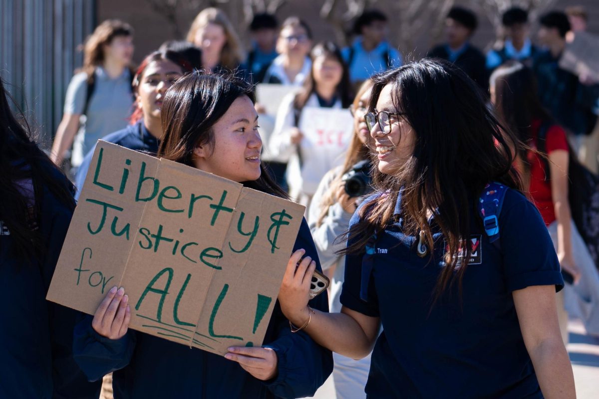 COLLABORATIVE MOVEMENT: Seniors Janet Tran and Maily Tran bring homemade signs out onto the streets of Cypress.