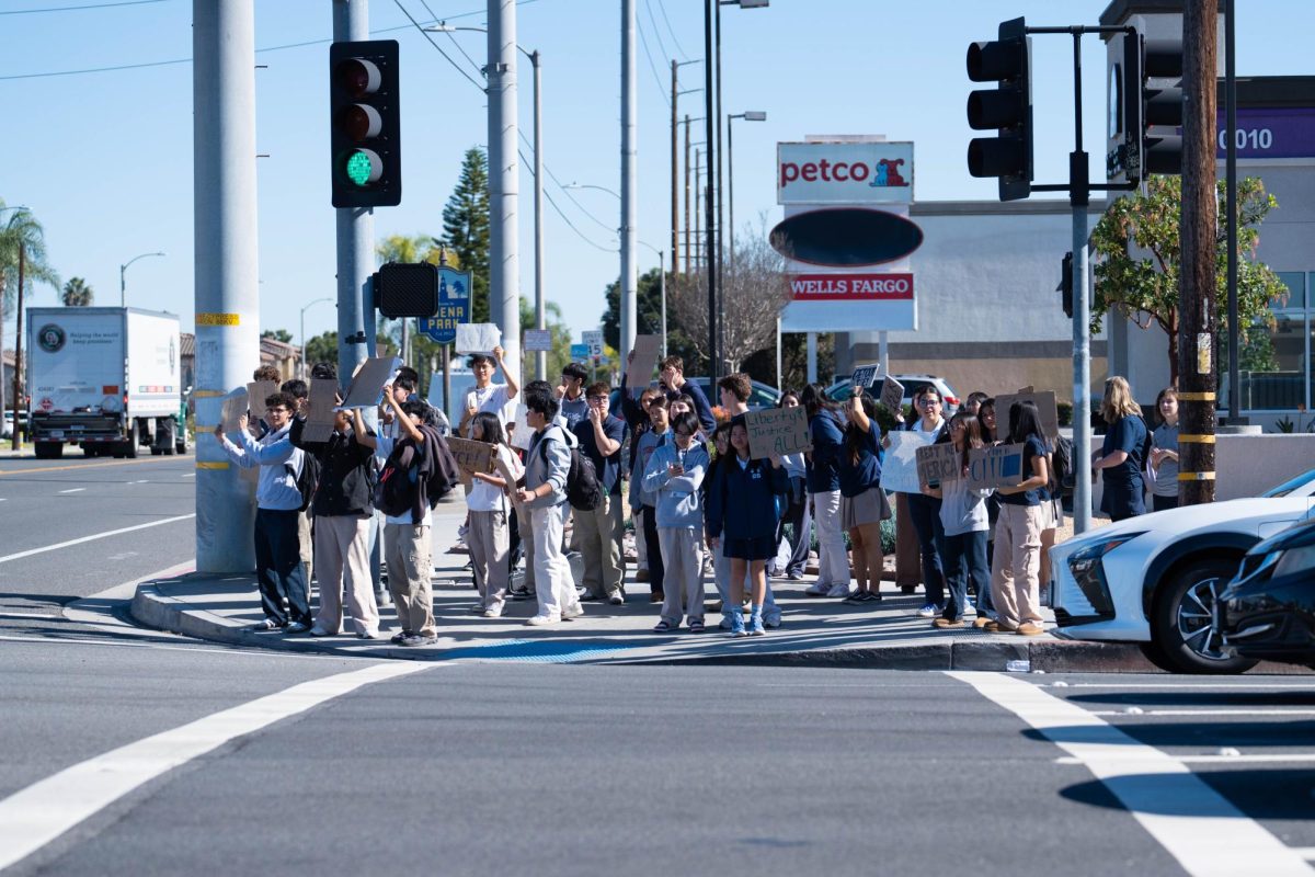 RAISING STUDENT VOICES: Oxford students gather at the corner of Valley View and Ball to protest the actions of ICE.