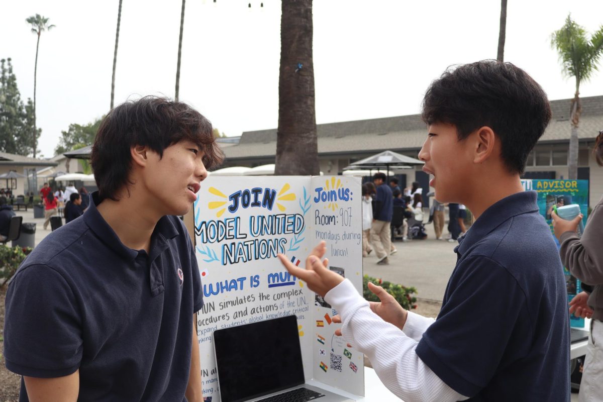 GARNERING INTEREST: Sophomore Jayden Lee pitches the Model United Nations club to freshman Brent Bang during club refresh. 