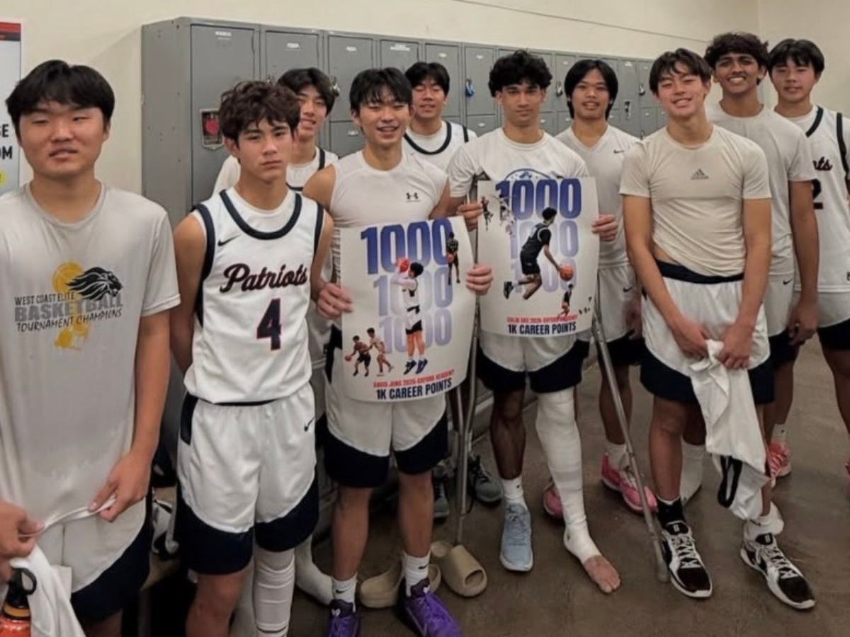 SCORING BIG: Senior Colin Das and David Jung celebrate their achievements surrounded by proud teammates. (Photo courtesy of Anthony Newman)