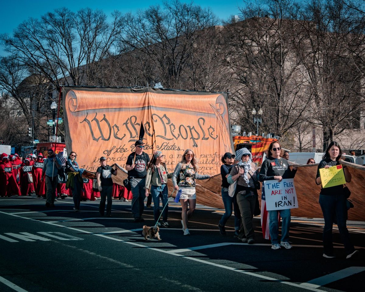 WE THE PEOPLE: Protestors hold signs depicting messages regarding the 2026 Iran war.